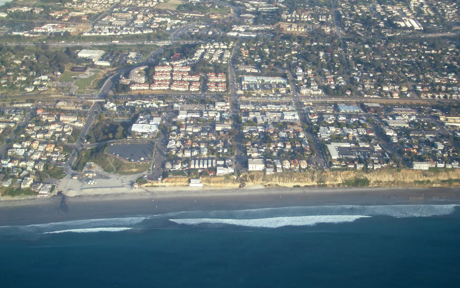 Moonlight Beach in Encinitas on a sunny day, showing the wide sandy beach and clear coastal scenery typical of North San Diego County
